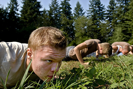 Troubled Teen Search - Adolescent boy getting disciplined at boot camp for youth